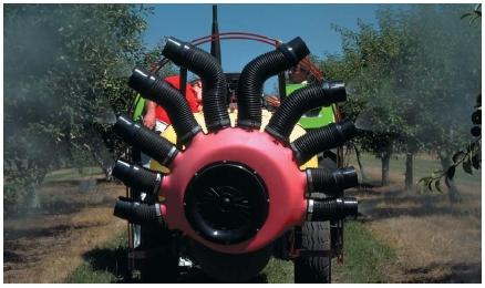 An orchard sprayer killing pests in fruit trees. (Reproduced by permission of Phototake.)