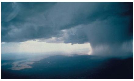 Cold fronts are usually accompanied by cumulonimbus thunderstorm clouds. (Reproduced by permission of National Center for Atmospheric Research.)