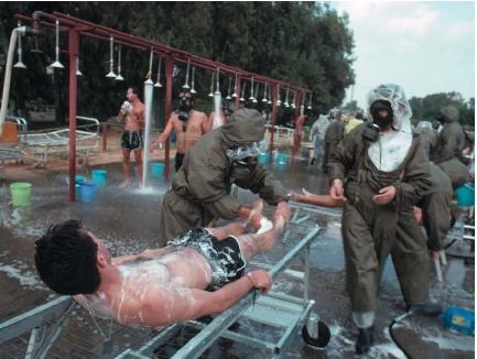 Soldiers at Assaf Harofe Hospital washing "victims" in a simulated chemical warfare attack. (Reproduced by permission of the Corbis Corporation [Bellevue].)
