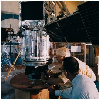 Technicians looking over the International Ultraviolet Explorer during magnetic checks, at Goddard Space Flight Center. (Reproduced by permission of The Corbis Corporation.)