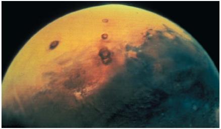 Mars, as seen from space by Viking 1. The planet is slightly more than one-tenth as massive as Earth. (Reproduced by permission of National Aeronautics and Space Administration.)