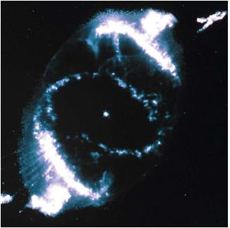 The Cat's Eye Nebula as seen from the Hubble Space Telescope. At center is a dying star during its last stages of life. Knots and thin filaments can be seen along the edge of the gas. (Reproduced by permission of National Aeronautics and Space Administration.)