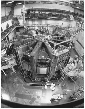 Tokamak 15, a nuclear fusion research reactor at the Kurchatov Institute in Moscow. The ring shape of the reactor is the design most favored by nuclear fusion researchers. The ring contains a plasma mixture of deuterium and tritium that is surrounded by powerful magnets that enclose the plasma with their fields and keep it away from the walls of the reactor vessel. At sufficiently high temperatures, the deuterium and tritium nuclei fuse, creating helium and energetic neutrons. It is these neutrons that carry the energy of the reactor. (Reproduced by permission of Photo Researchers, Inc.)