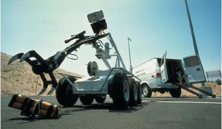 A police robot handling a live bomb by remote control. (Reproduced by permission of Photo Researchers, Inc.)